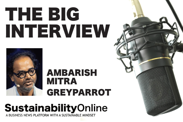 Podcast cover for SustainabilityOnline featuring bold 'THE BIG INTERVIEW' title, portrait of Ambarish Mitra, and a large microphone on the right with 'SustainabilityOnline' branding.