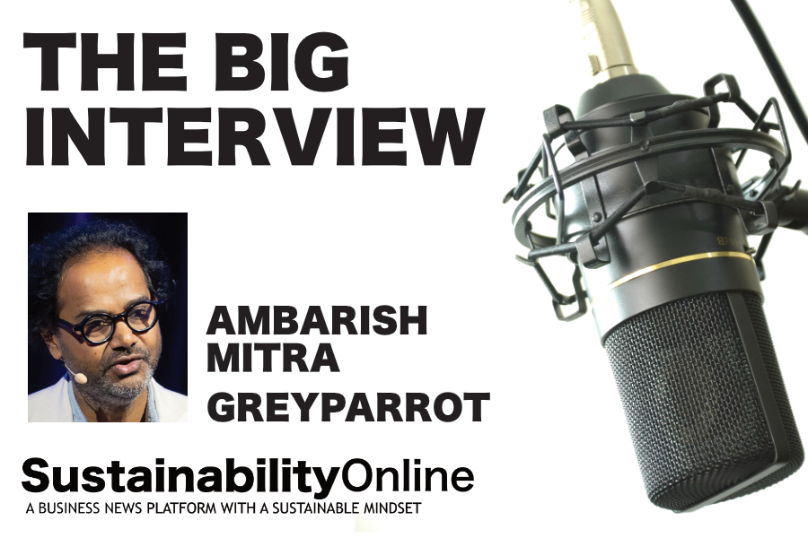 Podcast cover for SustainabilityOnline featuring bold 'THE BIG INTERVIEW' title, portrait of Ambarish Mitra, and a large microphone on the right with 'SustainabilityOnline' branding.