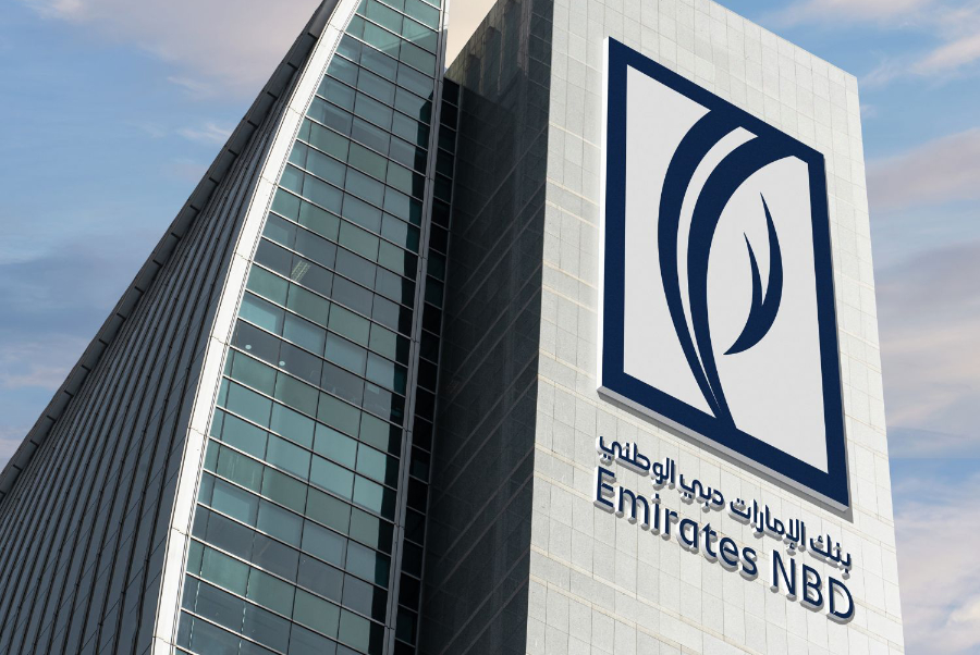 Modern bank building with Emirates NBD logo and Arabic text on a gray facade.